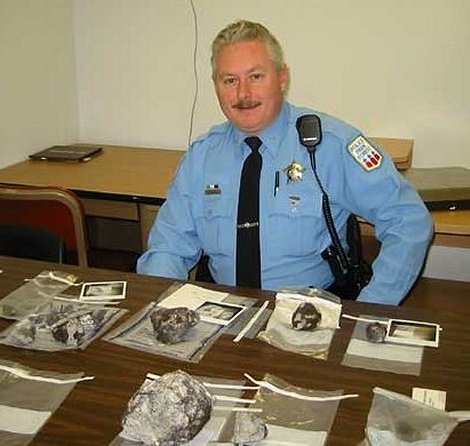 Officer Bob Doyle with several specimens from the fall, including the Garza fragments at front center